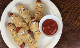 sausages baked in strips of dough to make sausage mummies